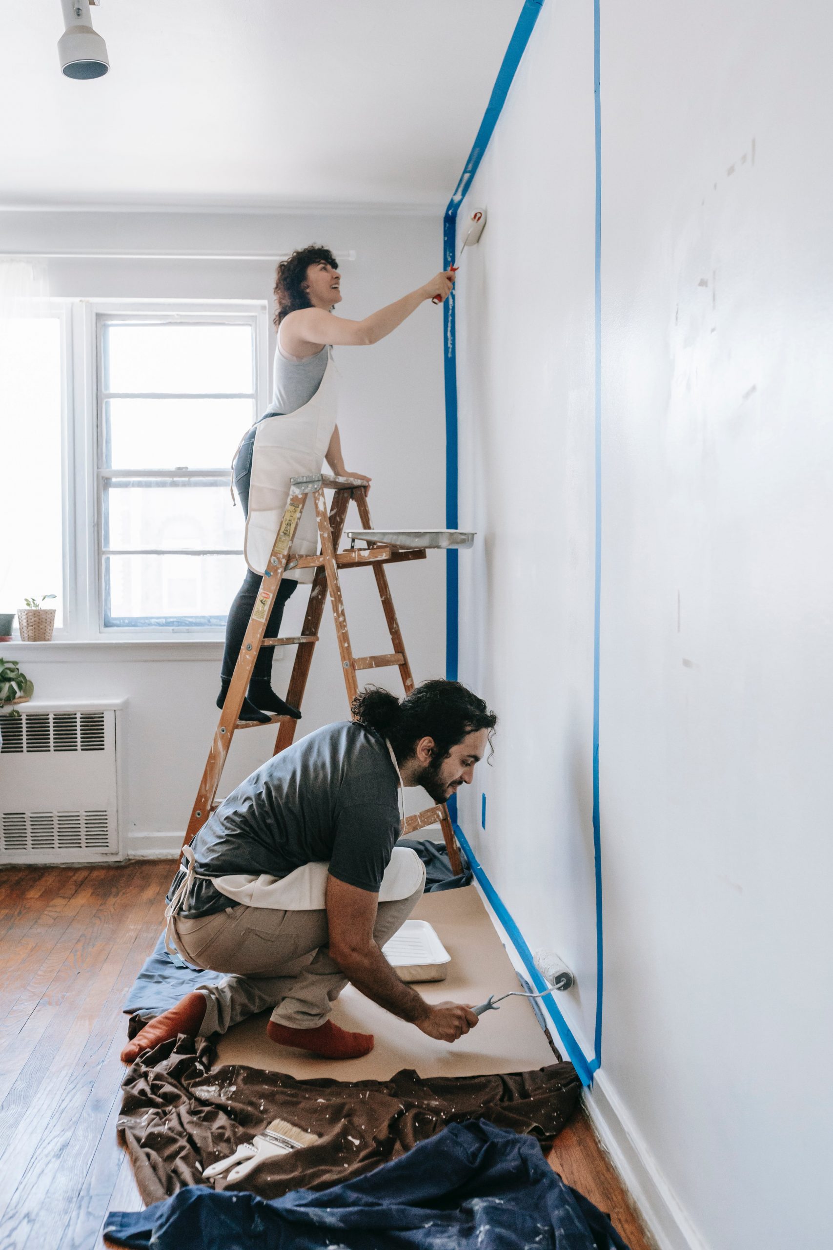 What not to fix when selling real estate picture of two people painting